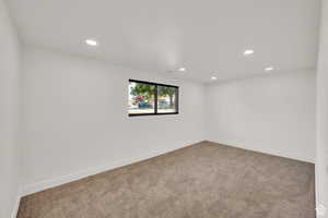 Spare room with light colored carpet and recessed lighting