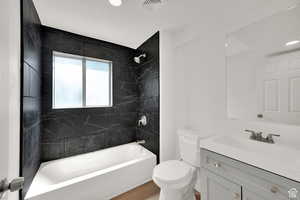 Full bath featuring vanity, shower / bathtub combination, and light wood finished floors