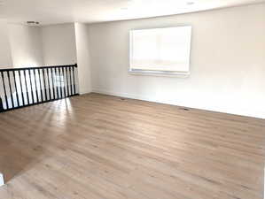 Spare room with light wood finished floors and baseboards