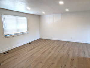 Spare room featuring light wood-style floors and recessed lighting