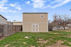 View of outbuilding with a fenced backyard