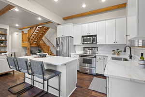 Stainless appliances and a breakfast bar