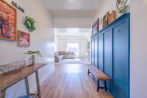 Corridor featuring light wood-type flooring and baseboards