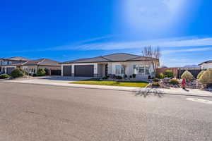View of front facade featuring an attached garage and concrete driveway