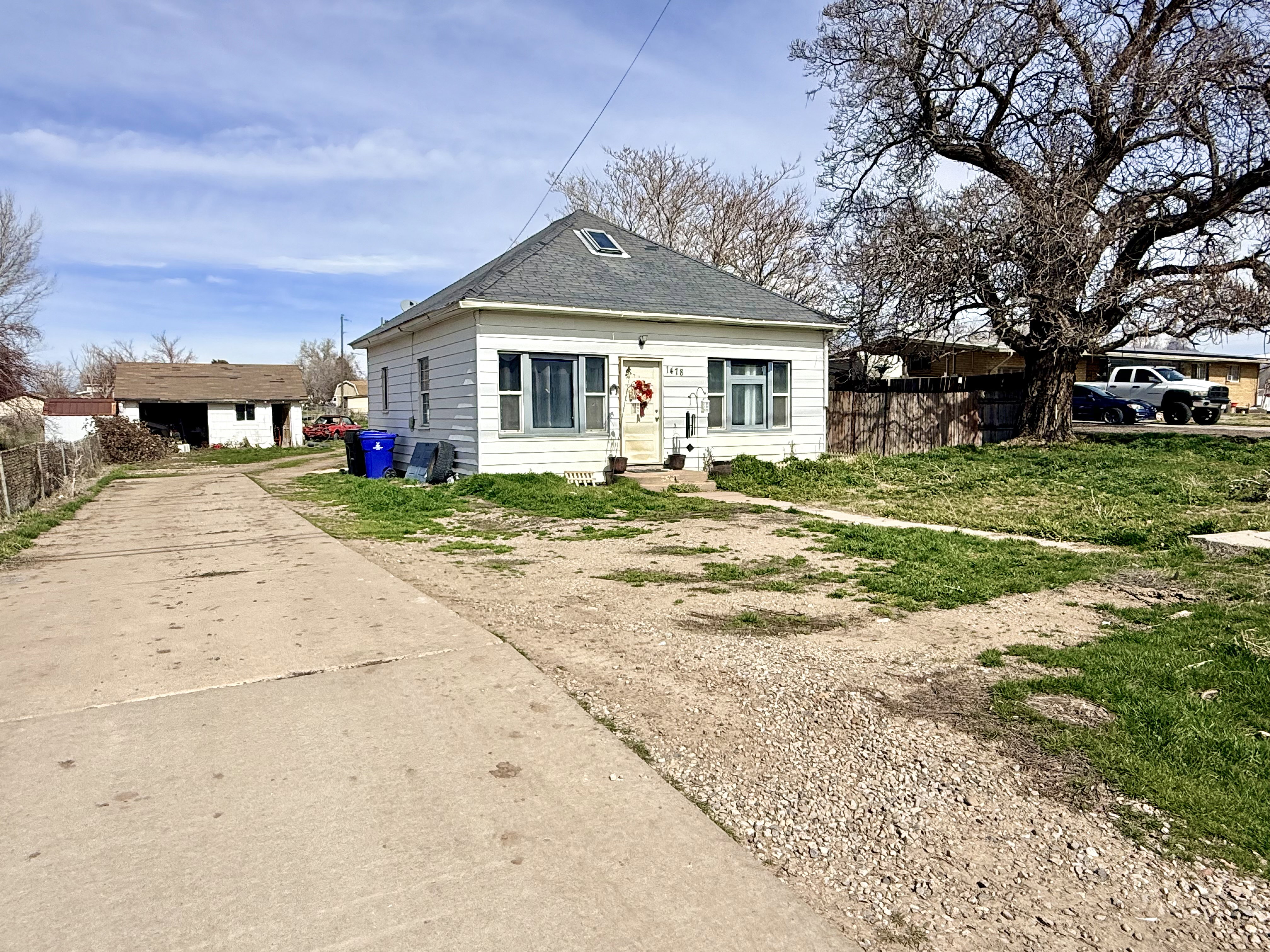 Bungalow-style house featuring concrete driveway and a shingled roof
