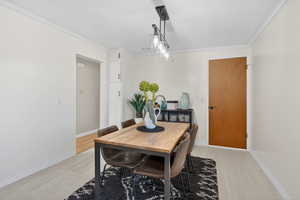 Dining area featuring baseboards and crown molding