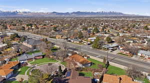 Aerial overview of property's location with nearby suburban area and a mountainous background