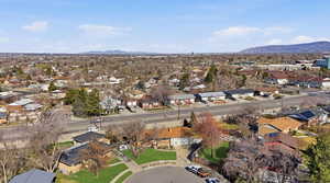 Aerial view of property and surrounding area with nearby suburban area