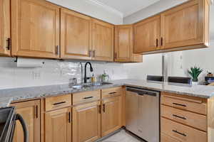 Kitchen featuring light stone countertops, tasteful backsplash, dishwasher, ornamental molding, and black range with electric cooktop