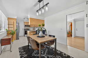 Dining room featuring crown molding and light tile patterned floors