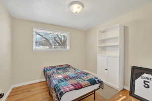 Bedroom with light wood-type flooring and baseboards