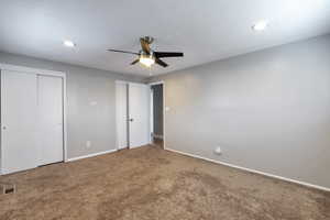 Unfurnished bedroom featuring two closets, carpet flooring, ceiling fan, and recessed lighting