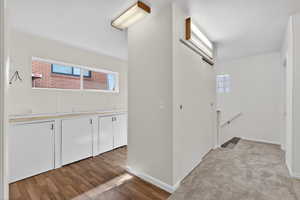 Versatile flex area featuring integrated storage and ample counter space. Bathed in natural light, this multi-purpose nook off the kitchen is perfect for hobbies, organization, or additional prep space.