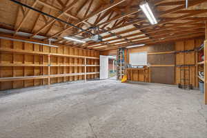 Spacious 2-car garage featuring a workbench and extensive built-in storage on both sides.