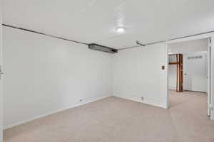 Below grade flex-room with a closet. This space is ideally suited for storage, a hobby room or a future bedroom (buyer to verify city requirements).