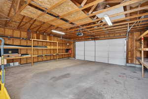 Spacious 2-car garage featuring extensive built-in storage and an automatic garage door opener.