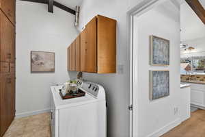Functional laundry room featuring a utility sink, abundant storage, and independent washer/dryer.