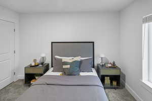 Bedroom featuring carpet and baseboards