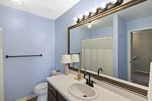 Bathroom featuring vanity and curtained shower