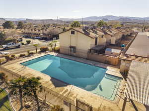 Community pool with a patio area, a residential view, a pergola, and a mountain view