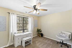 Sitting room featuring carpet and ceiling fan