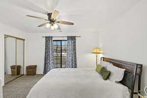 Carpeted bedroom featuring a closet and a ceiling fan