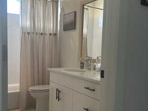 Bathroom with vanity, shower/bath combination, and light marble finish floors