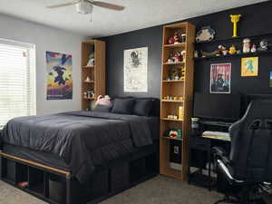 Bedroom with large window and a ceiling fan