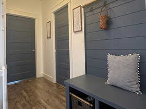 Mudroom area featuring wood-style floor and built-ins