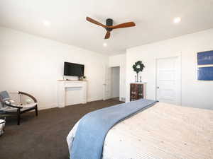 Primary bedroom with ceiling fan, carpet, large windows, and recessed lighting