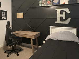 Bedroom featuring custom wall molding and large window