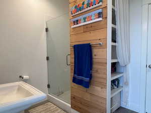 Bathroom with indoor/outdoor access with a shower stall