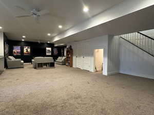 Carpeted great room with open floor plan, ceiling fan, and recessed lighting