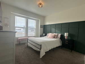 Bedroom featuring a large windows and custom wall molding