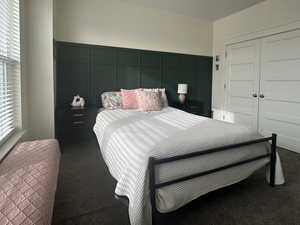 Bedroom featuring a large closet and custom wall molding
