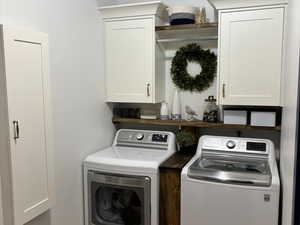 Laundry area featuring cabinet space, washer and dryer