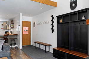 Mudroom with dark wood finished floors and recessed lighting