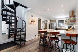 Dining room featuring dark wood-style floors and recessed lighting