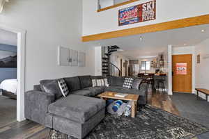 Living area featuring dark wood-style flooring and recessed lighting