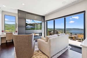 Living area with light wood finished floors, a desk, and recessed lighting