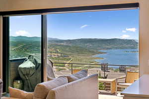 Balcony featuring a water and mountain view