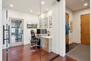 Office space with recessed lighting and dark wood-type flooring
