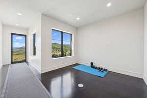 Exercise area featuring a mountain view, recessed lighting, and concrete floors