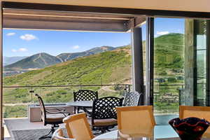 Balcony featuring a mountain view and outdoor dining space