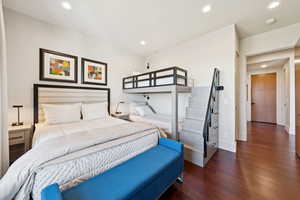 Bedroom with dark wood-style floors and recessed lighting