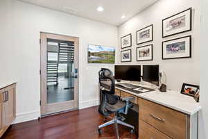 Office area featuring dark wood finished floors and recessed lighting