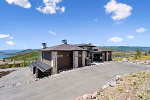 Prairie-style house featuring a mountain view and a chimney