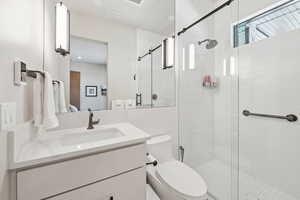 Full bath featuring vanity and a stall shower