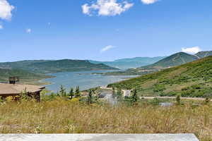 View of mountain backdrop featuring a nearby body of water