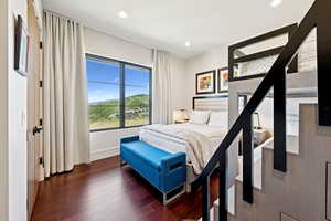 Bedroom with hardwood / wood-style floors, a mountain view, and recessed lighting